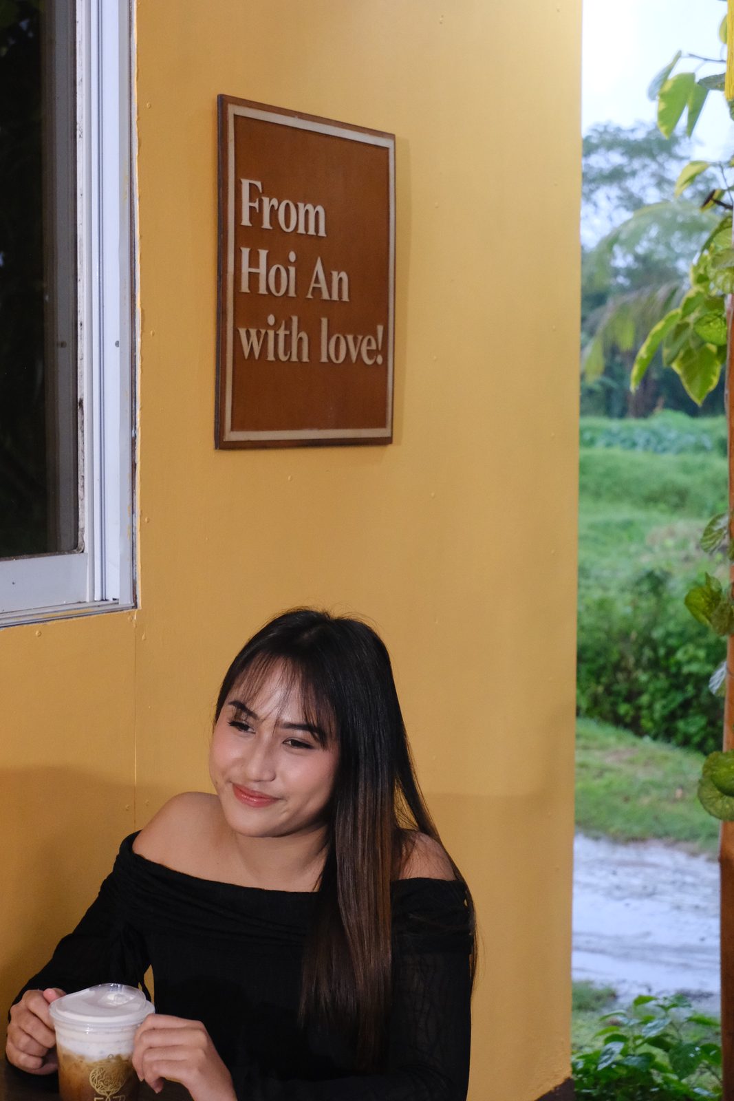 Guest beside the From Hội An with love welcome sign